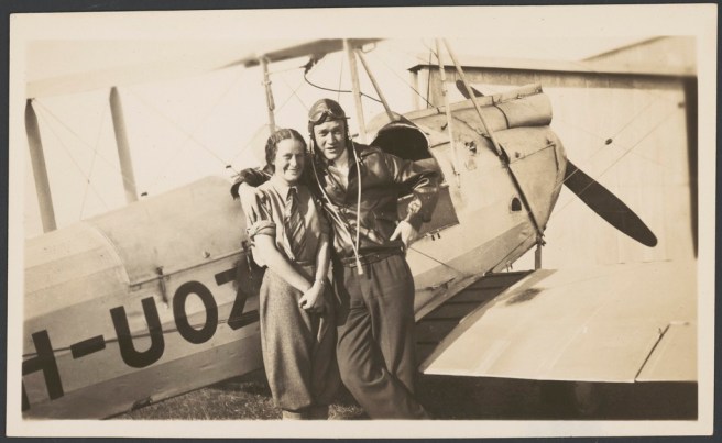 Nancy Bird and Jack Kingsford-Smith standing next to a de Havilland DH.60M Moth (VH-UOZ), Mascot [?], New South Wales, ca. 1933, 1 / E. A. Crome